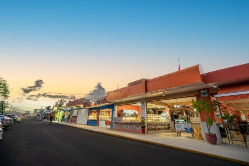 a street with shops on the side of the road at Olas Del Mar Beach Apartment in Luquillo