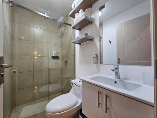 a bathroom with a toilet and a sink and a shower at Charming Retreat Heredia: Your Home Away from Home in Heredia