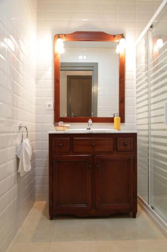 a bathroom with a sink and a mirror at La Masia in Sant Pere Pescador