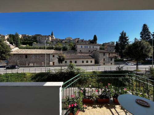 a view of a city from a balcony with flowers at Il Balconcino su Spello in Spello