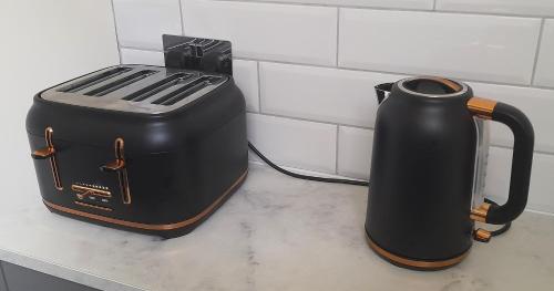 a toaster and coffee maker sitting on a counter at Kirkcudbright Holiday Apartments - Apartment D in Kirkcudbright