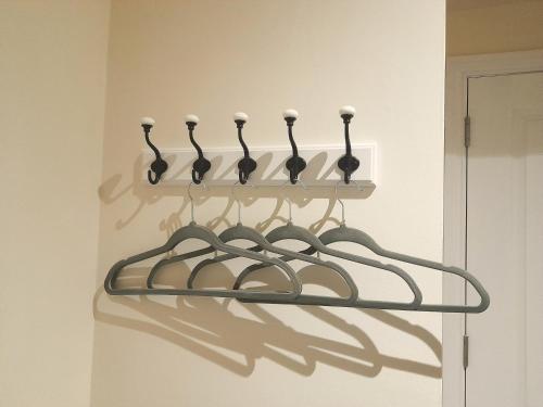 a rack of utensils hanging on a wall at Kirkcudbright Holiday Apartments - Apartment D in Kirkcudbright