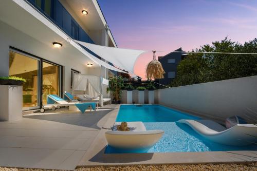 a backyard with a swimming pool and a house at Adriatic Paradise Villa in Vodice
