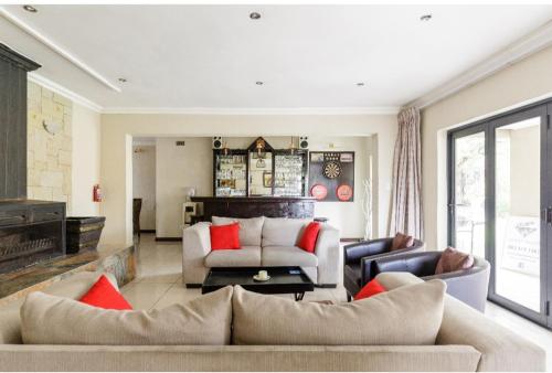 a living room with a couch and a table at Jewel of Jozi in Edenvale