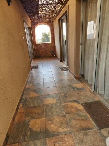 a hallway of a house with a tile floor at Jewel of Jozi in Edenvale