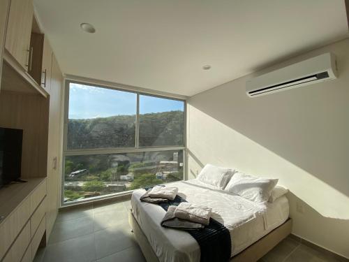 Postel nebo postele na pokoji v ubytování Colibrí Arena - Santa Marta - Aparta Suite 1019