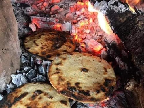 a group of food cooking on top of a grill at Cora Izone in Cob&aacute;n
