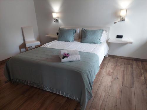 a bedroom with a bed with a stuffed animal on it at Casa Xavier in Ponta Delgada