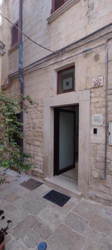 a building with a large door on the side of it at Dimora la Motta in Modugno