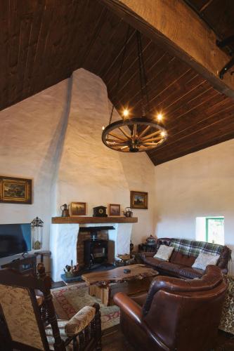 a living room with a couch and a fireplace at Maggie Deenys Cottage in Lackagh