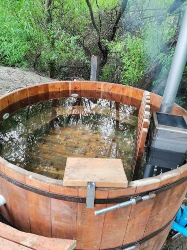 a wooden barrel with a pond of water in it at Casa Cochrane in Cochrane