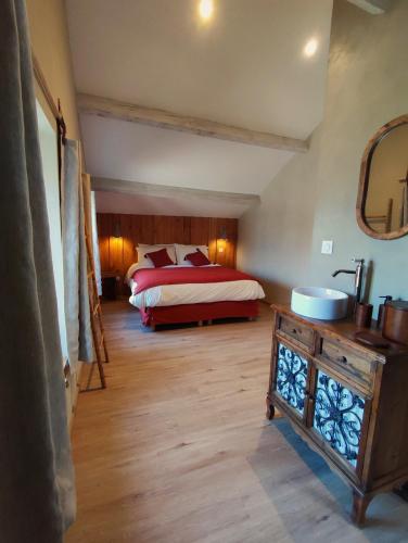 a bedroom with a bed and a dresser in it at L'Escapade Authentique in Brouchaud