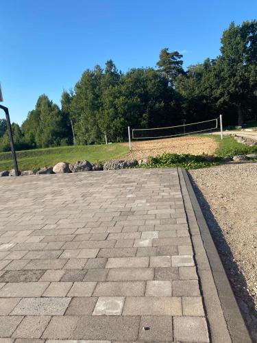 a volleyball court in a park with trees in the background at Luobos vienkiemis in Luoba