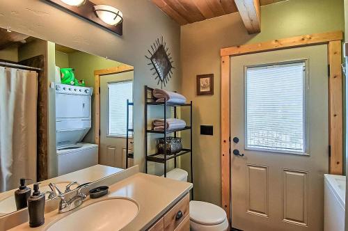 a bathroom with a sink and a toilet and a mirror at Shasta Lake Luxury Log Cabin: Hot tub & Pool in Lakeshore