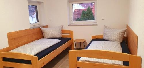 two beds in a small room with a window at Eibauer Apartments in Sinsheim