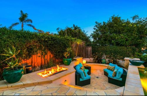 a backyard with a fire pit and chairs and a fence at Breathtaking La Playa Getaway With Golf Cart Use! in San Diego