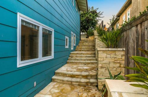 a blue house with stairs leading up to a window at Breathtaking La Playa Getaway With Golf Cart Use! in San Diego