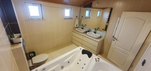 a bathroom with a tub and a toilet and a sink at Hotel House in Arnavutköy