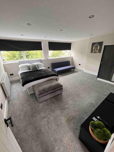 a large bedroom with two beds and a couch at Modern 5 Bedroom Terraced Luxurious House in Colwyn Bay