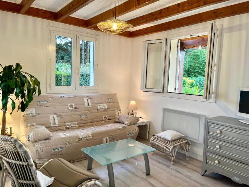 a living room with a couch and a table at Villa Bleu soleil in Pornic