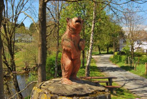 a statue of a bear standing on a rock at Chalet Panor'Anna in Saint-Vith