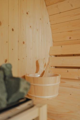 a sauna with wooden walls and a wooden tub at Chalet Panor'Anna in Saint-Vith