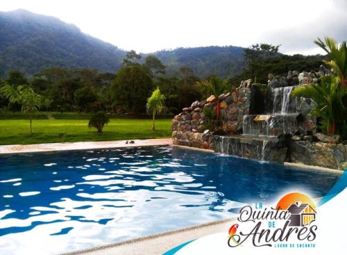 a swimming pool with a waterfall in the background at La Quinta de Andrés in San Isidro