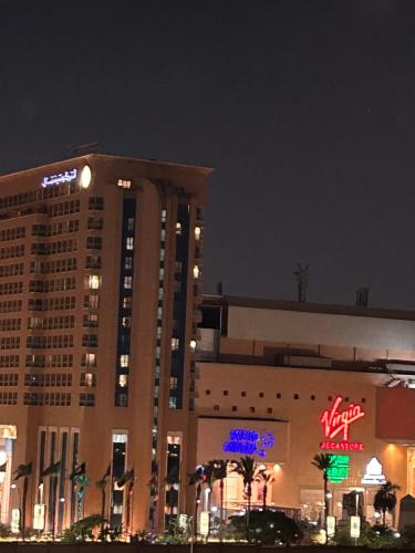 un grand bâtiment avec un panneau la nuit dans l'établissement Ramo City Stars Hotel, au Caire