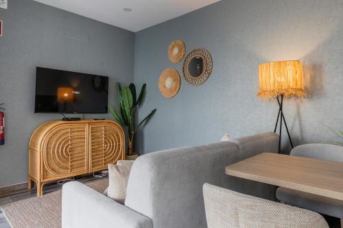a living room with a couch and a tv at Blue Apartments in Leiria