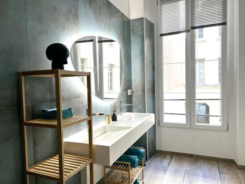 a bathroom with a sink and a mirror at MARAIS Appartement 2 Chambres 2 Salles de bain - SPA JACUZZI ! in Paris