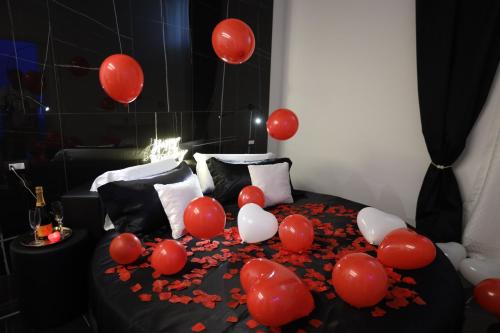 a bed with red and white balloons on it at 50m2 Suite in Capurso