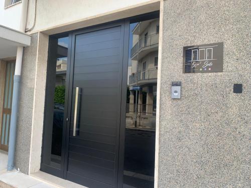 a large glass door of a building at 50m2 Suite in Capurso