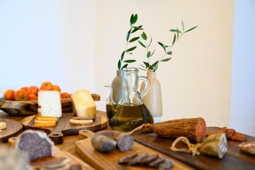 a table topped with different types of bread and cheese at Llucmaçanes Gran Agroturismo in Mahón
