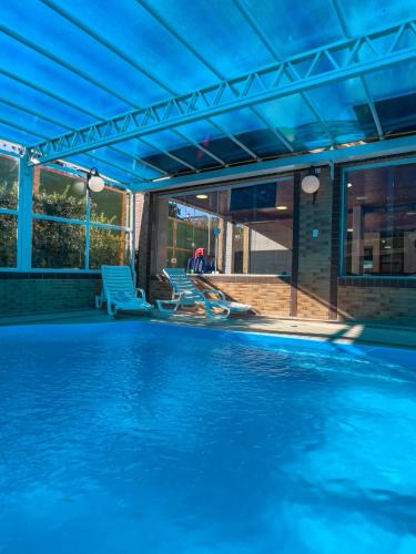 a woman laying on the side of a swimming pool at Hotel Palazzo Reale in Campos do Jordão