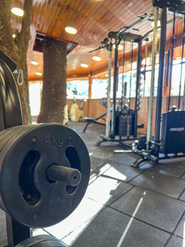 a gym with several treadmills and machines at Hotel Palazzo Reale in Campos do Jordão