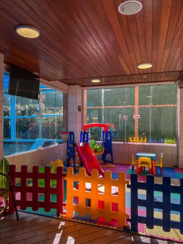 a room with a play area with a playground at Hotel Palazzo Reale in Campos do Jordão