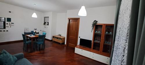 a living room with a table and a dining room at Regina Ciclarum Suite in Fiumicino