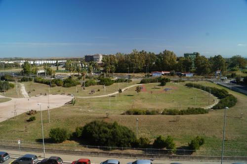 a park with cars parked in a parking lot at Regina Ciclarum Suite in Fiumicino