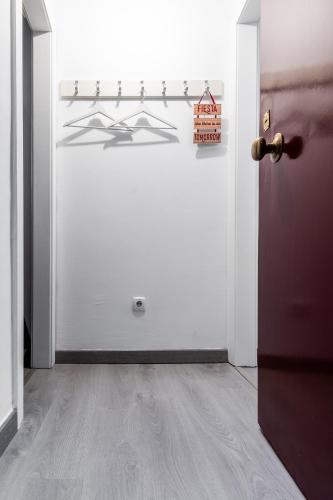 a room with a door and a white wall at Apartamento com escada e pátio, em frente praia in Paço de Arcos