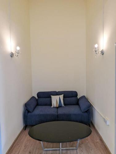 a living room with a blue couch and a table at Villa Coco - Flic en Flac in Flic-en-Flac