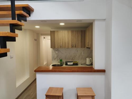 a kitchen with wooden cabinets and a counter top at Old Town apartments in Novi Sad