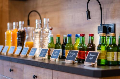 a counter with different types of bottles of wine at Gästehaus Hochkönig in Filzmoos