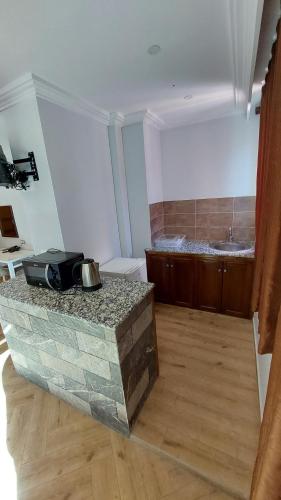 a bathroom with a sink and a bath tub at Hotel Blador in Tichi