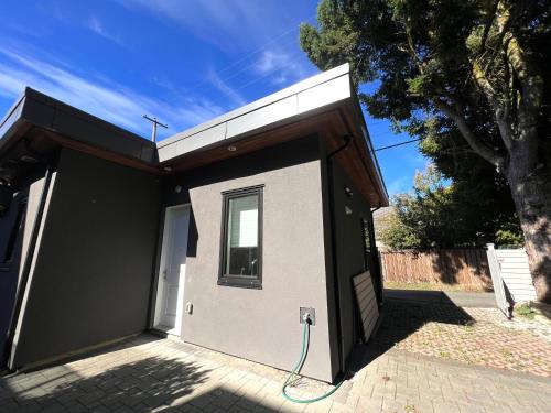 a small house with a hose attached to it at Brand New Modern Laneway House in Vancouver