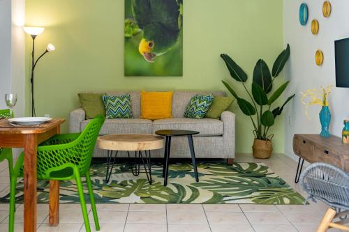 a living room with a couch and a table and chairs at Diver's Paradise Bonaire in Kralendijk