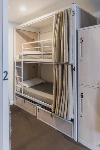 an empty room with two bunk beds in it at The Social Hotel, Sydney in Sydney