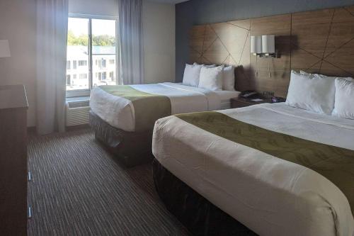 a hotel room with two beds and a window at Quality Inn & Suites Northampton - Amherst in Northampton