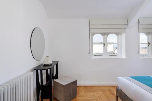 a white living room with a table and a couch at FOX ON THE HOE in Plymouth