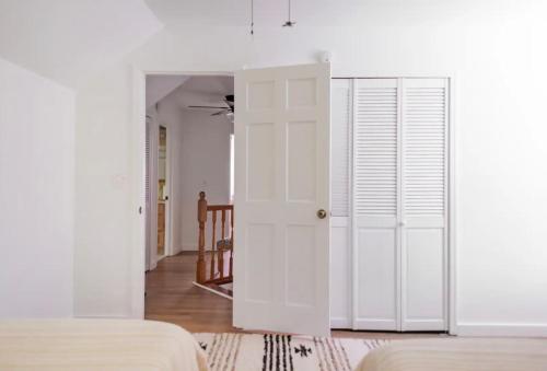 a bedroom with white walls and a white door at Catskill Cabin with Firepit & Brilliant Fall Views in Catskill
