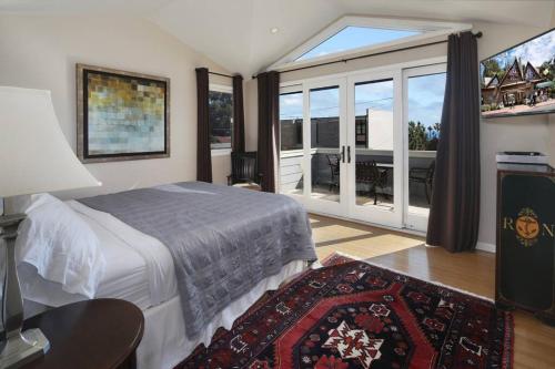a bedroom with a bed and a large window at Laguna Beach Modern Home-beach across st/town 1blk in Laguna Beach